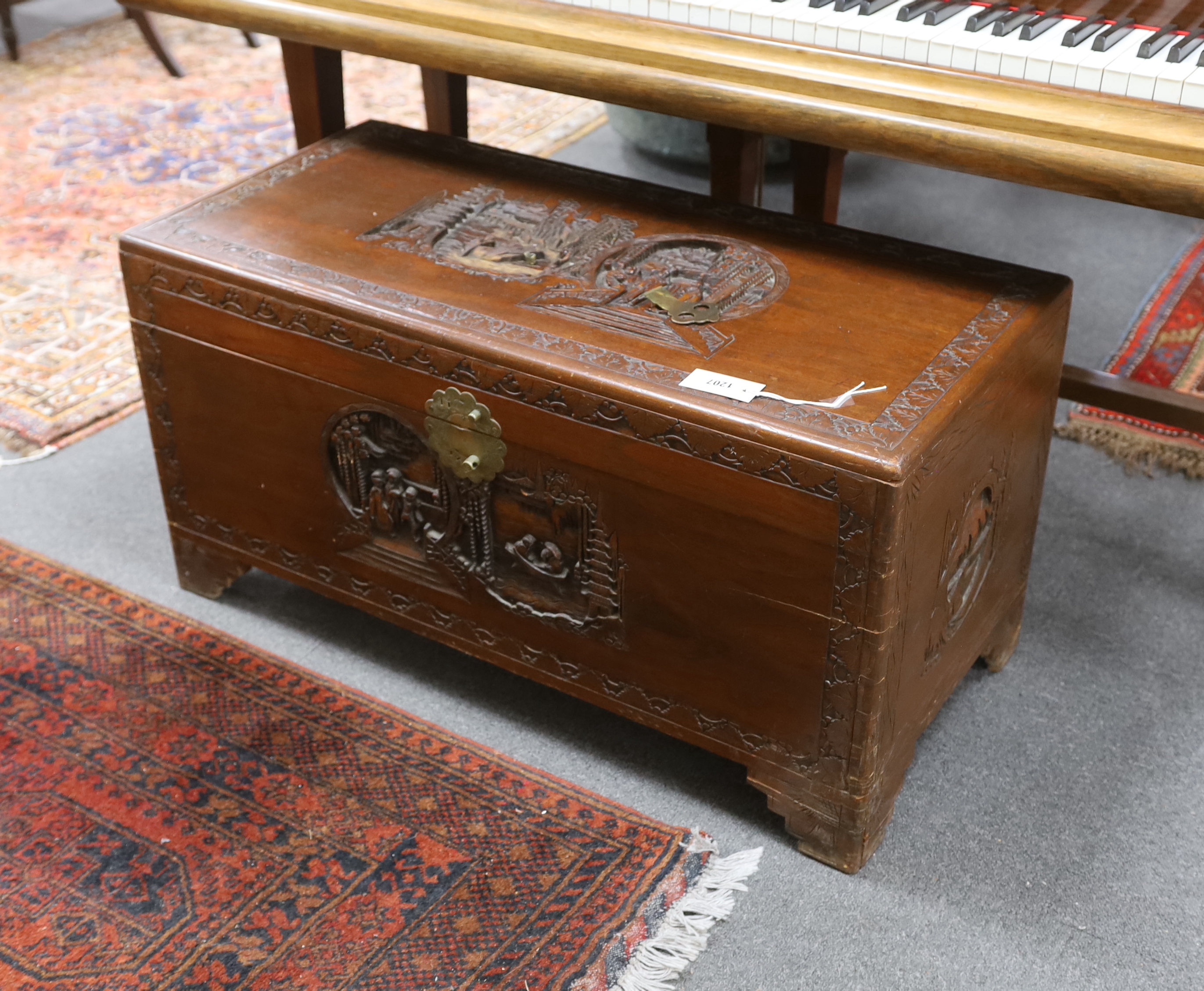 A Chinese carved camphor wood trunk, width 93cm, depth 44cm, height 48cm